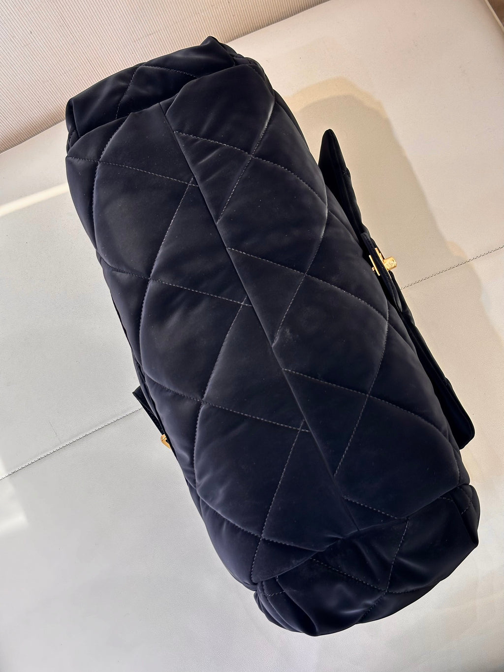 Chanel quilted shoulder bag in dark navy with angled profile and gold hardware