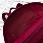 Gucci burgundy duffel bag interior with side zipper track and small logo patch labels