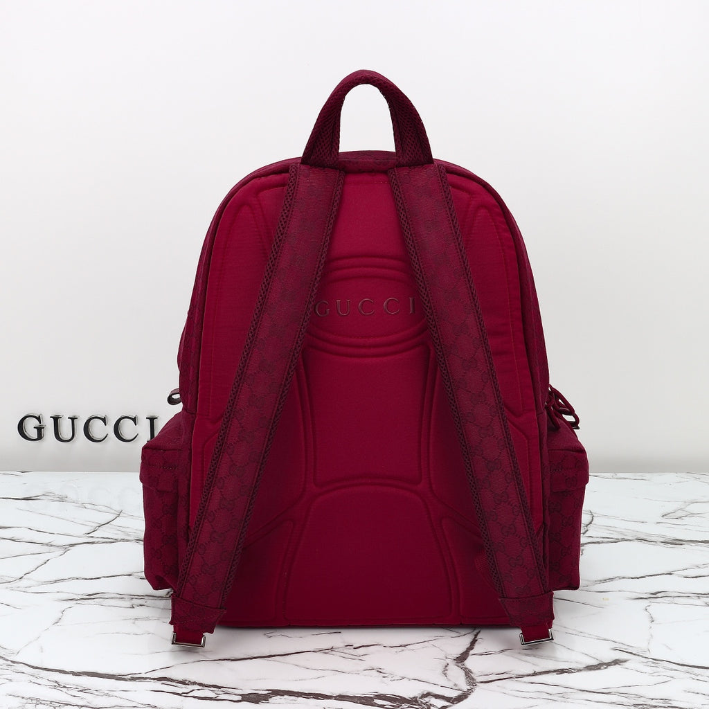 Gucci burgundy GG-pattern backpack with two adjustable shoulder straps and rear panel