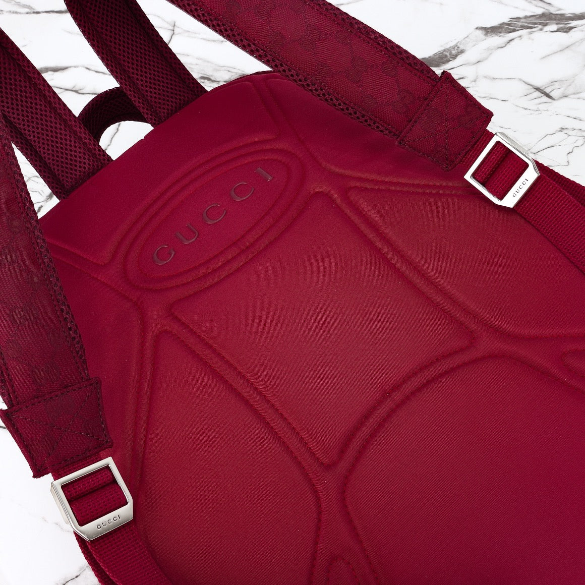 Gucci burgundy tote bag with embossed logo front and web straps with silver buckles