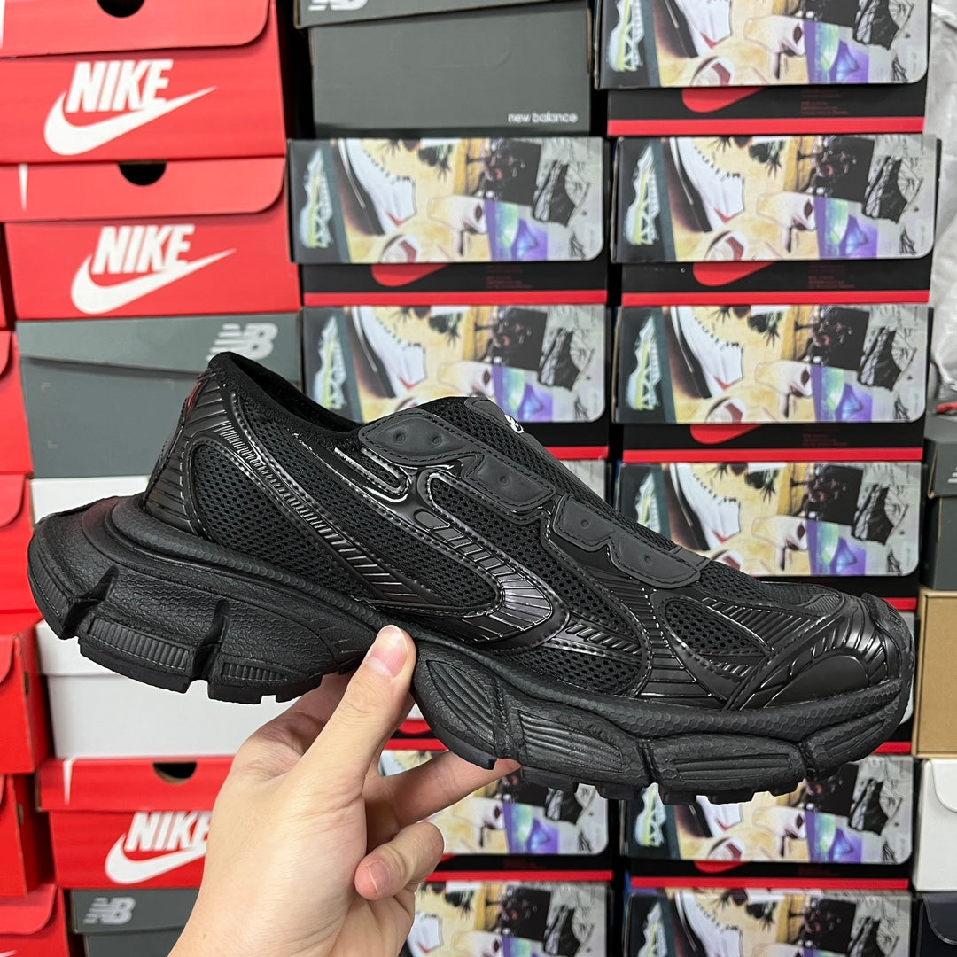 Balenciaga unisex sneakers front three-quarter view, black mesh upper and chunky sole