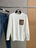 Gucci white crewneck sweater with small brown logo patch on chest pocket