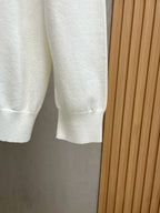 White crewneck sweatshirt side view with ribbed cuffs and hem