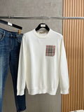White crewneck sweatshirt with long sleeves and plaid logo chest patch