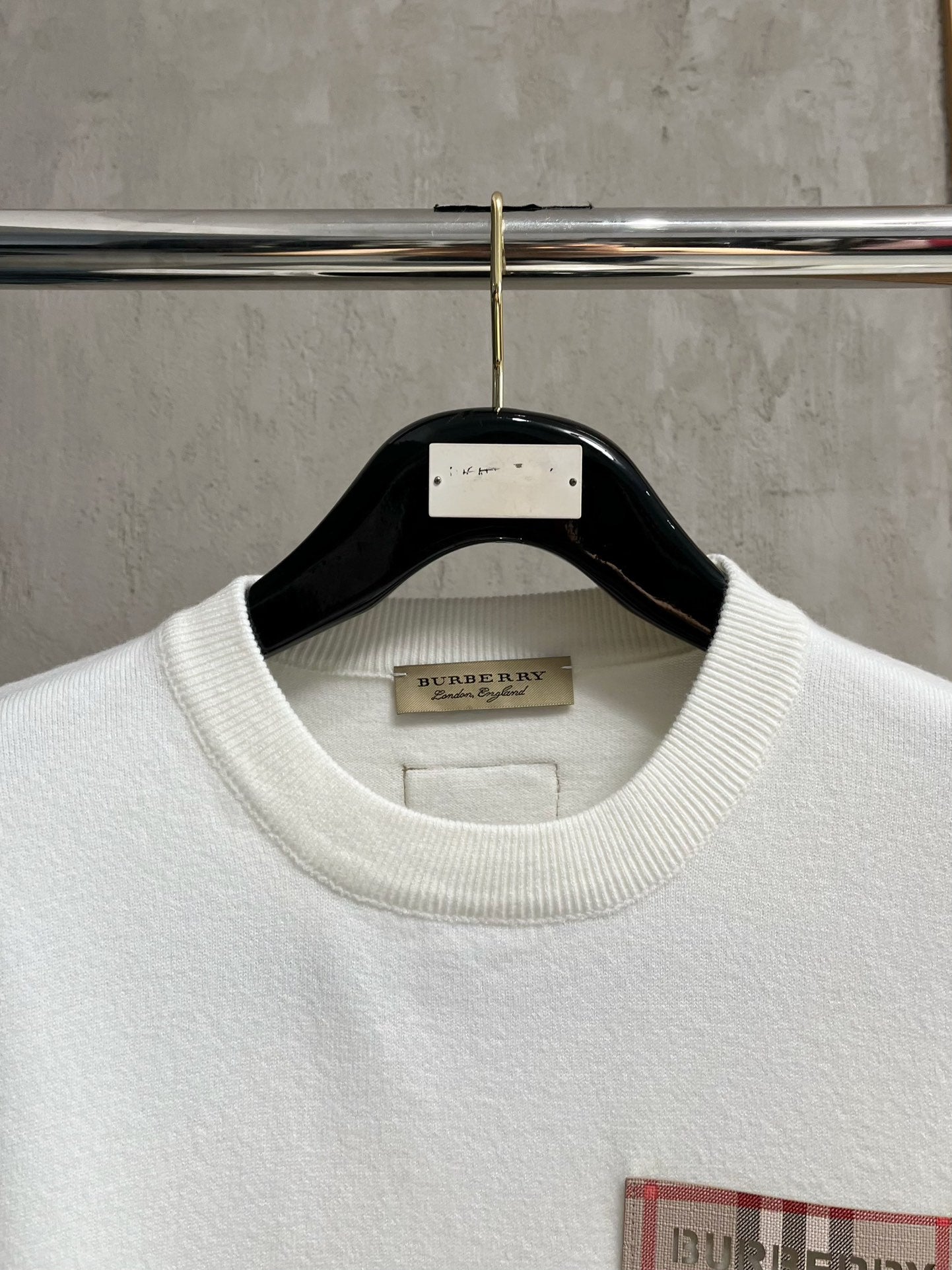 White crewneck sweatshirt neckline with ribbed collar and interior neck label