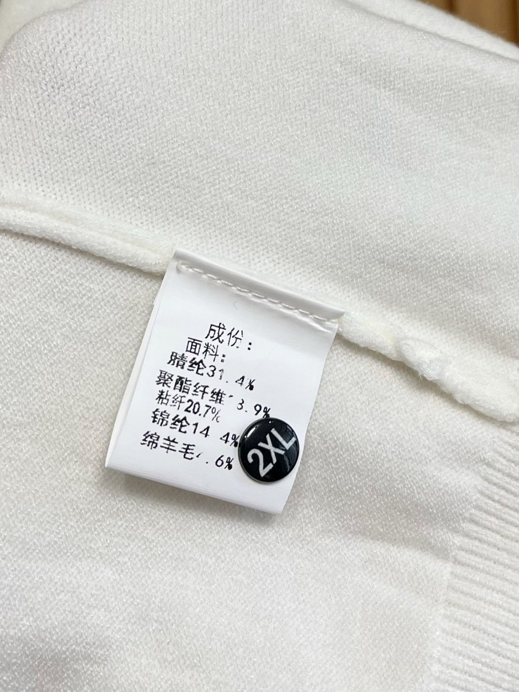 White sweatshirt size and fabric label marked 2XL