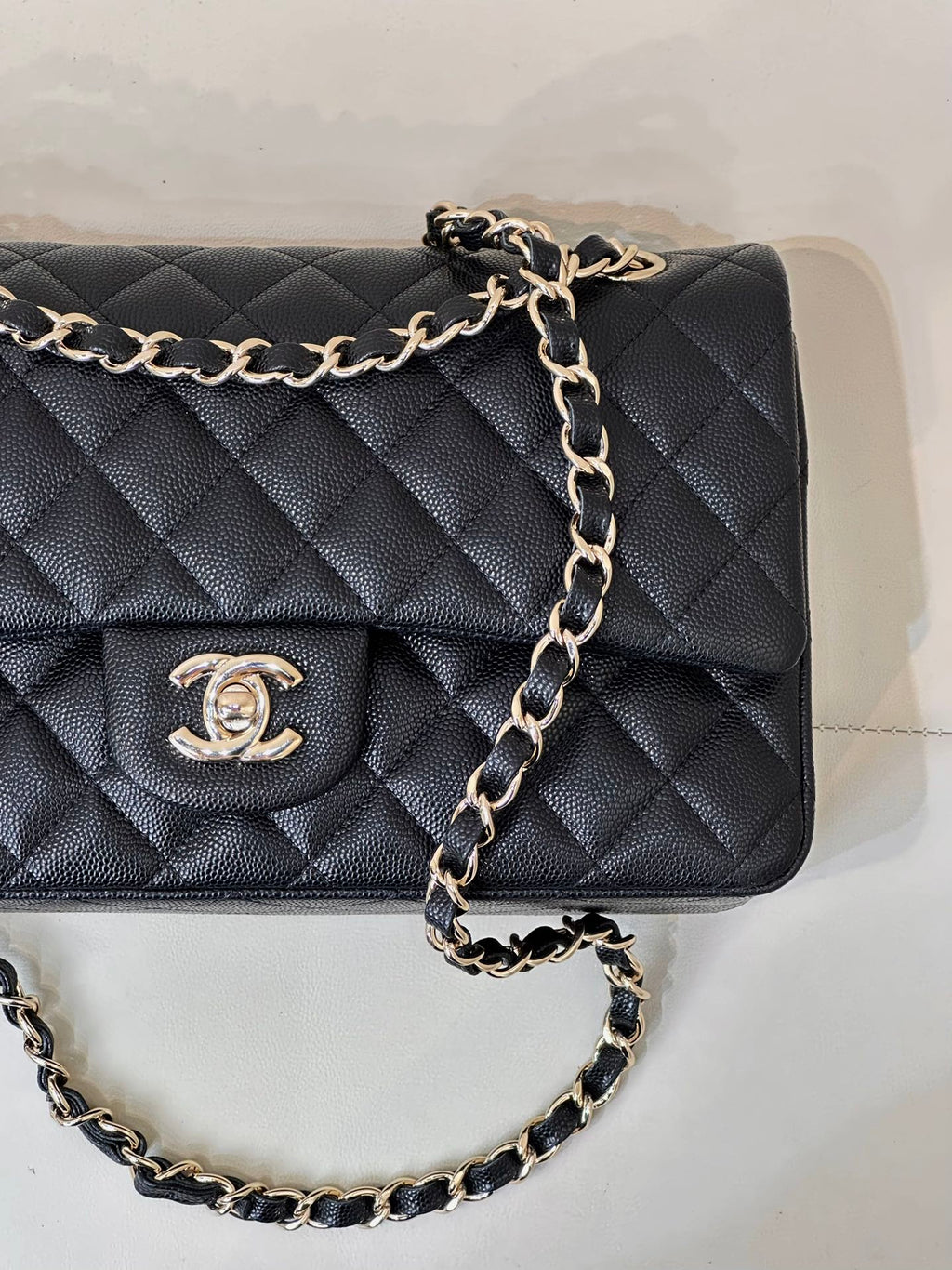 Chanel dark navy quilted flap shoulder bag close-up with CC logo on front
