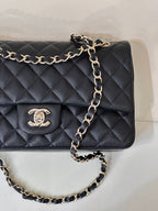 Chanel dark navy quilted flap shoulder bag close-up with CC logo on front
