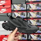 Black knit lace-up sneaker front view with white logo stripes and chunky sole