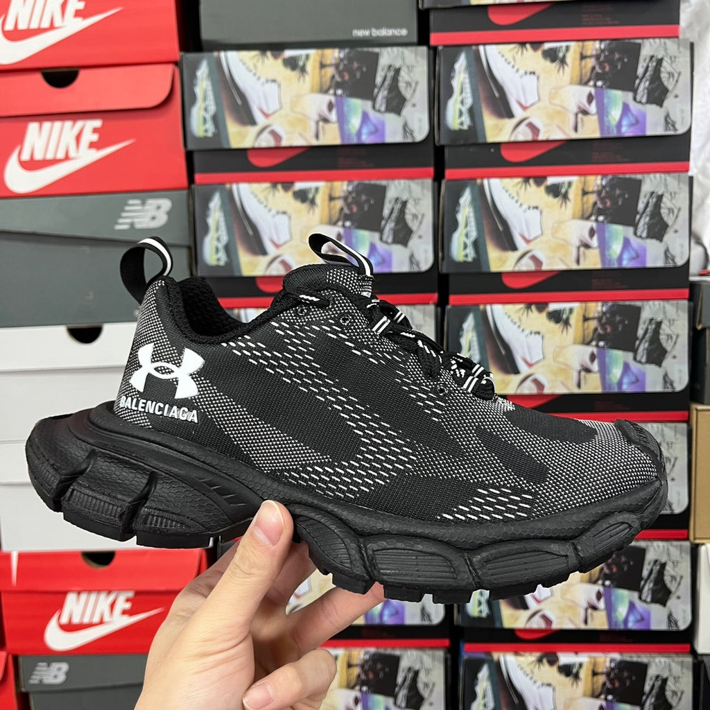 Black knit unisex sneaker with lace-up front, white logo detailing, chunky rubber sole