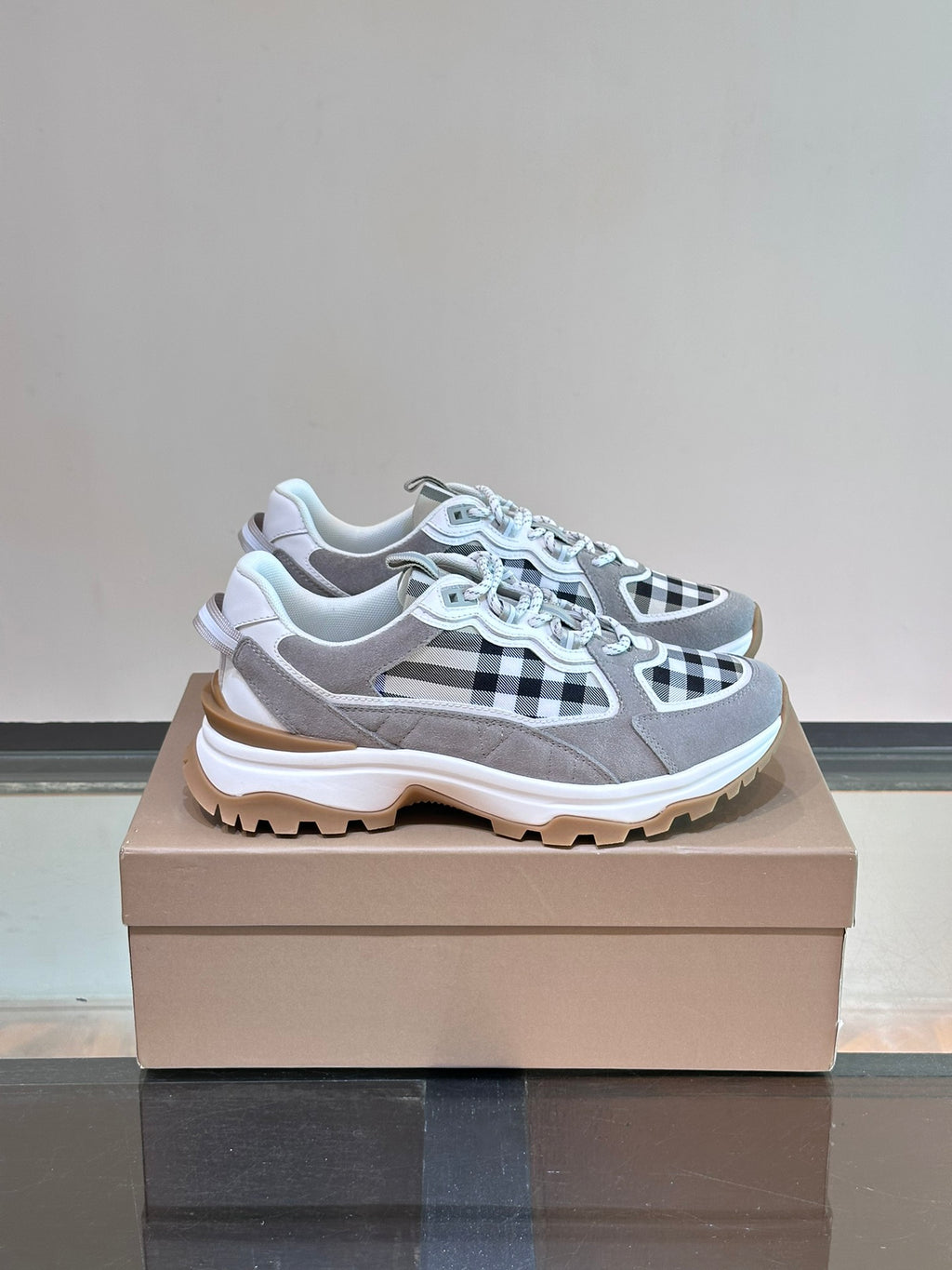 Burberry lace-up sneakers with grey upper and black-and-white check panels, chunky sole