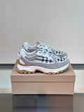 Burberry lace-up sneakers with grey upper and black-and-white check panels, chunky sole