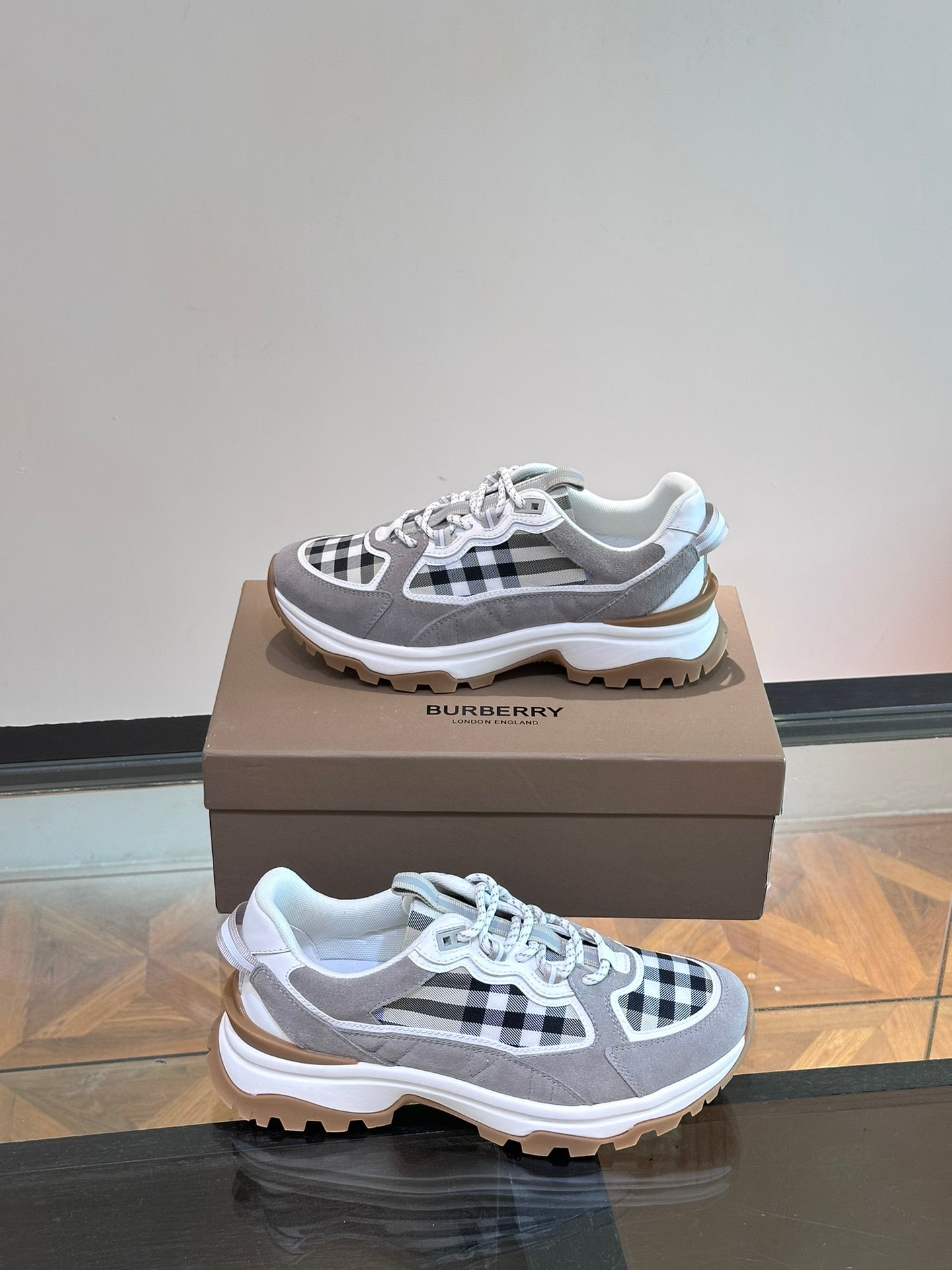 Burberry lace-up sneakers in grey with black-and-white check accents and rugged sole