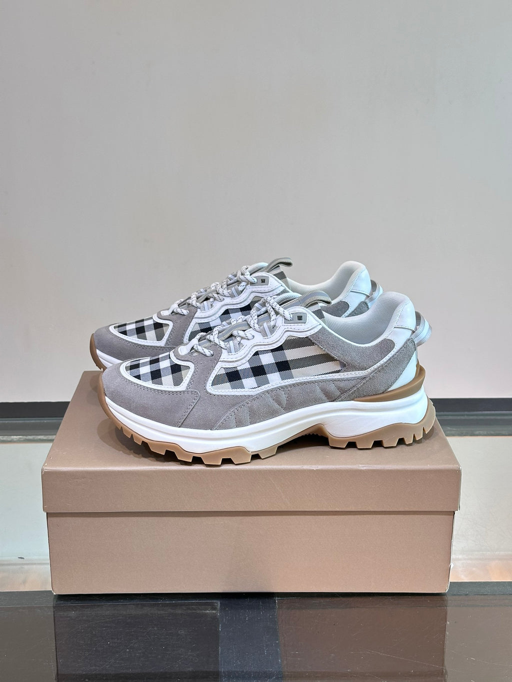 Burberry grey lace-up sneaker with black-and-white check overlays and thick rubber outsole