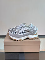 Burberry grey lace-up sneaker with black-and-white check overlays and thick rubber outsole