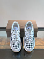 Burberry lace-up sneakers with grey uppers, blue lining, and black-and-white check details