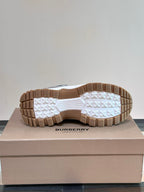 Burberry sneakers outsole view with tread pattern and brown rubber sole base