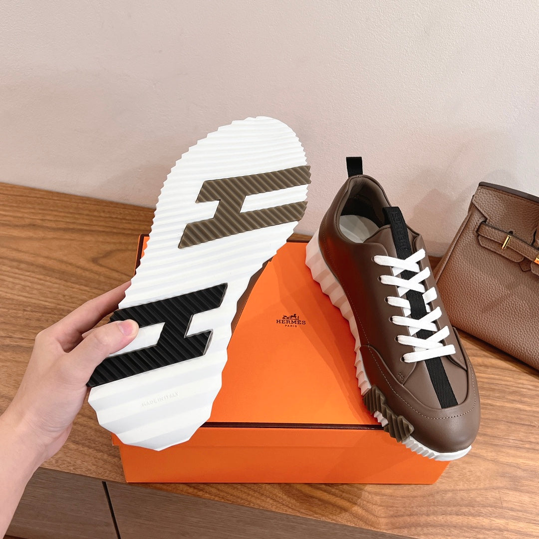 Hermes unisex sneaker outsole, white tread with dark grips, brown upper