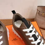 Hermes unisex sneakers, brown leather upper with black lace panel and white laces