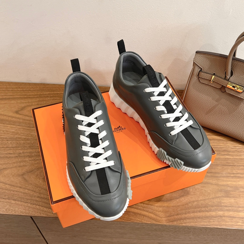 Unisex dark gray sneakers with white laces and cushioned textured sole