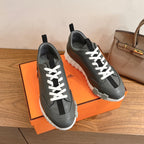 Unisex dark gray sneakers with white laces and cushioned textured sole