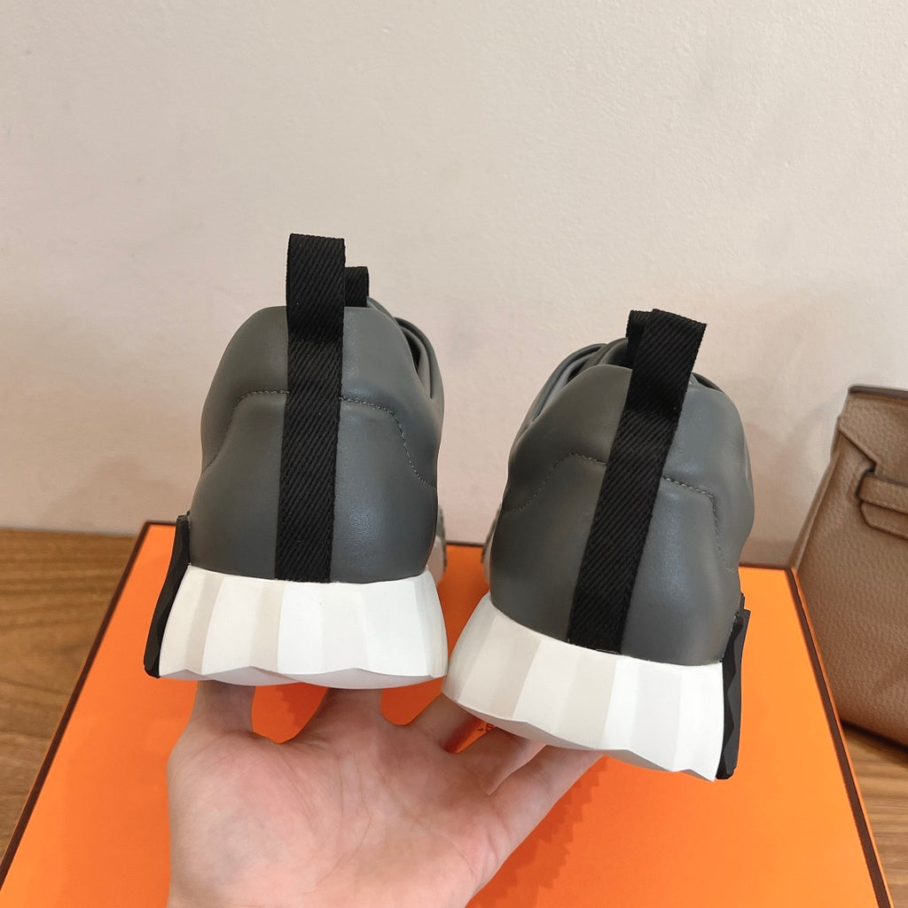 Unisex dark gray sneakers with black heel tabs and white cushioned soles