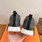 Unisex dark gray sneakers with black heel tabs and white cushioned soles