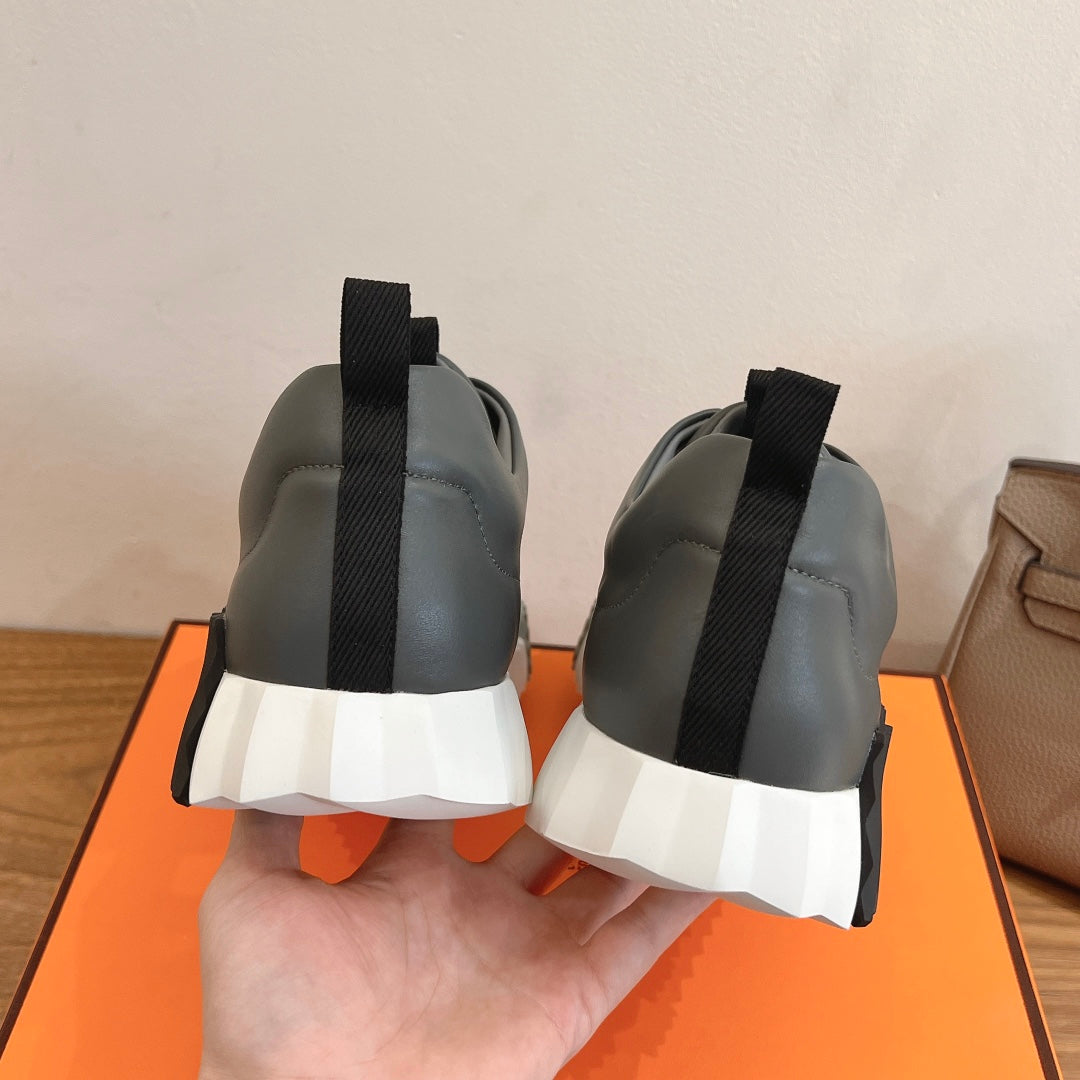 Unisex dark gray sneakers with black heel tabs and white cushioned soles