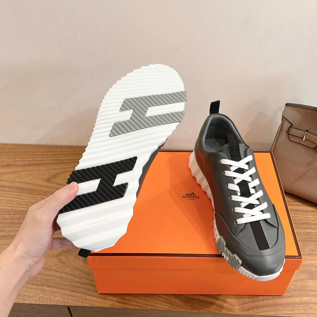 Unisex dark gray sneakers with white laces; visible white traction outsole