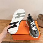 Unisex dark gray sneakers with white laces; visible white traction outsole