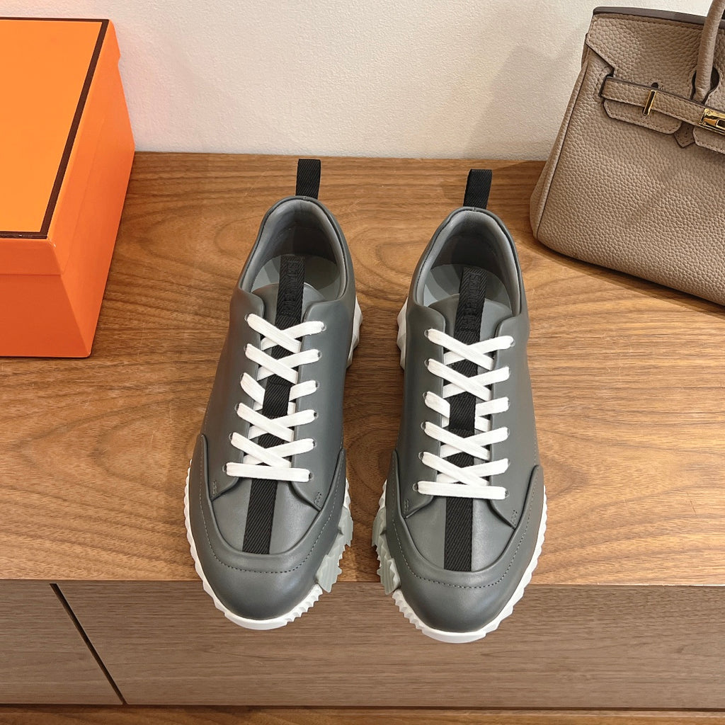 Unisex dark gray leather sneakers with white laces and rubber sole
