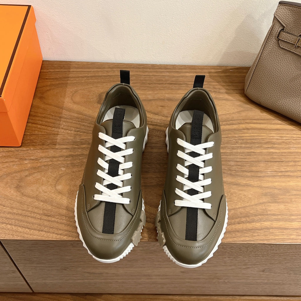 Hermes unisex olive leather sneaker with white laces, black side stripe, chunky white sole