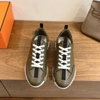 Hermes unisex olive leather sneaker with white laces, black side stripe, chunky white sole