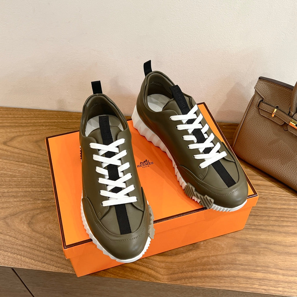 Olive leather sneakers with white laces and thick white tread sole