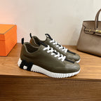 Olive leather low-top sneaker with white laces, black accents, chunky white sole