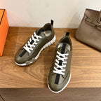Olive leather sneakers with white laces and black heel tabs, chunky white sole