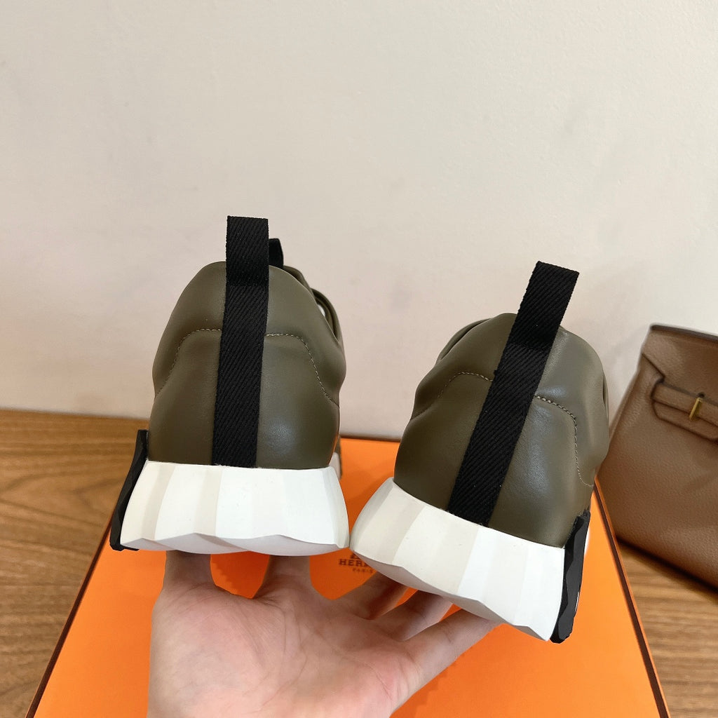 Olive leather sneakers with black pull-on tabs and white midsole