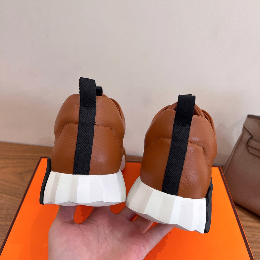 Tan leather sneaker heels with black elastic strap and white cushioned sole