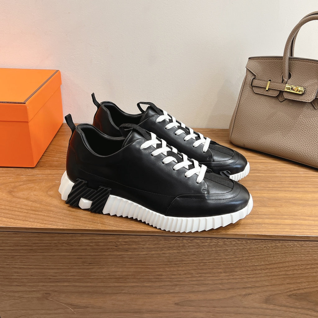 Black leather lace-up sneaker with white laces and white treaded midsole