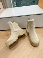 Pair of Louis Vuitton suede ankle boots in beige, shearling cuffs and ribbed sole