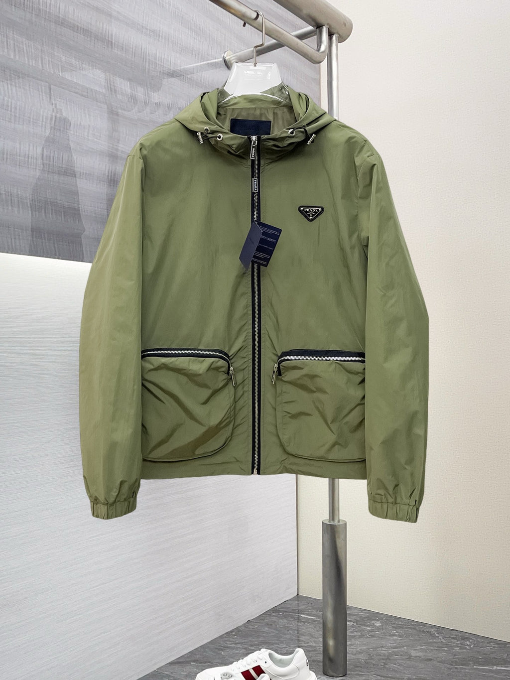 Prada hooded long jacket in olive green with front zip and flap pockets