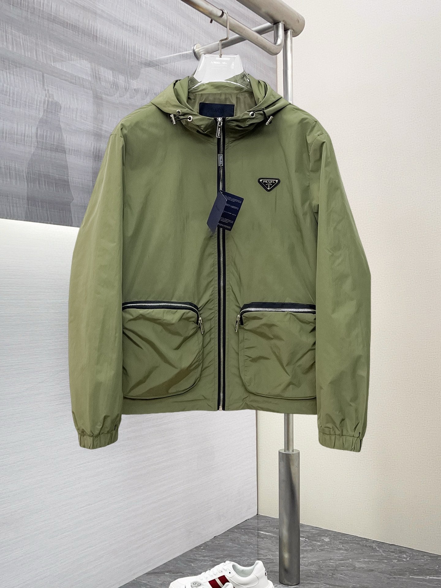 Prada hooded long jacket in olive green with front zip and flap pockets
