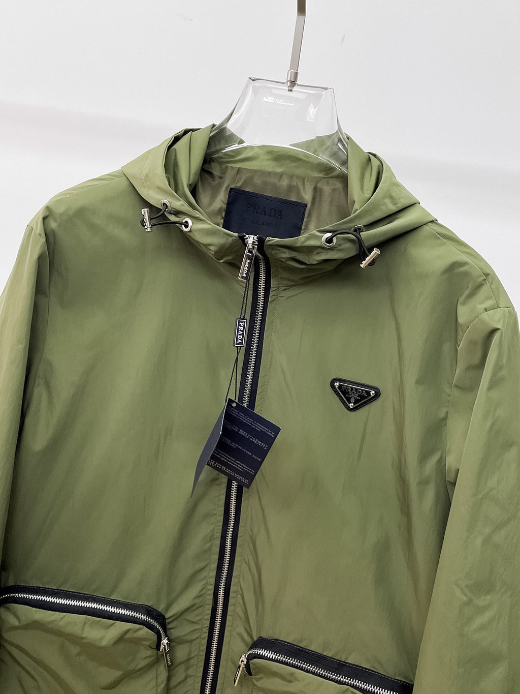 Prada hooded long jacket close-up with front zip and logo patch