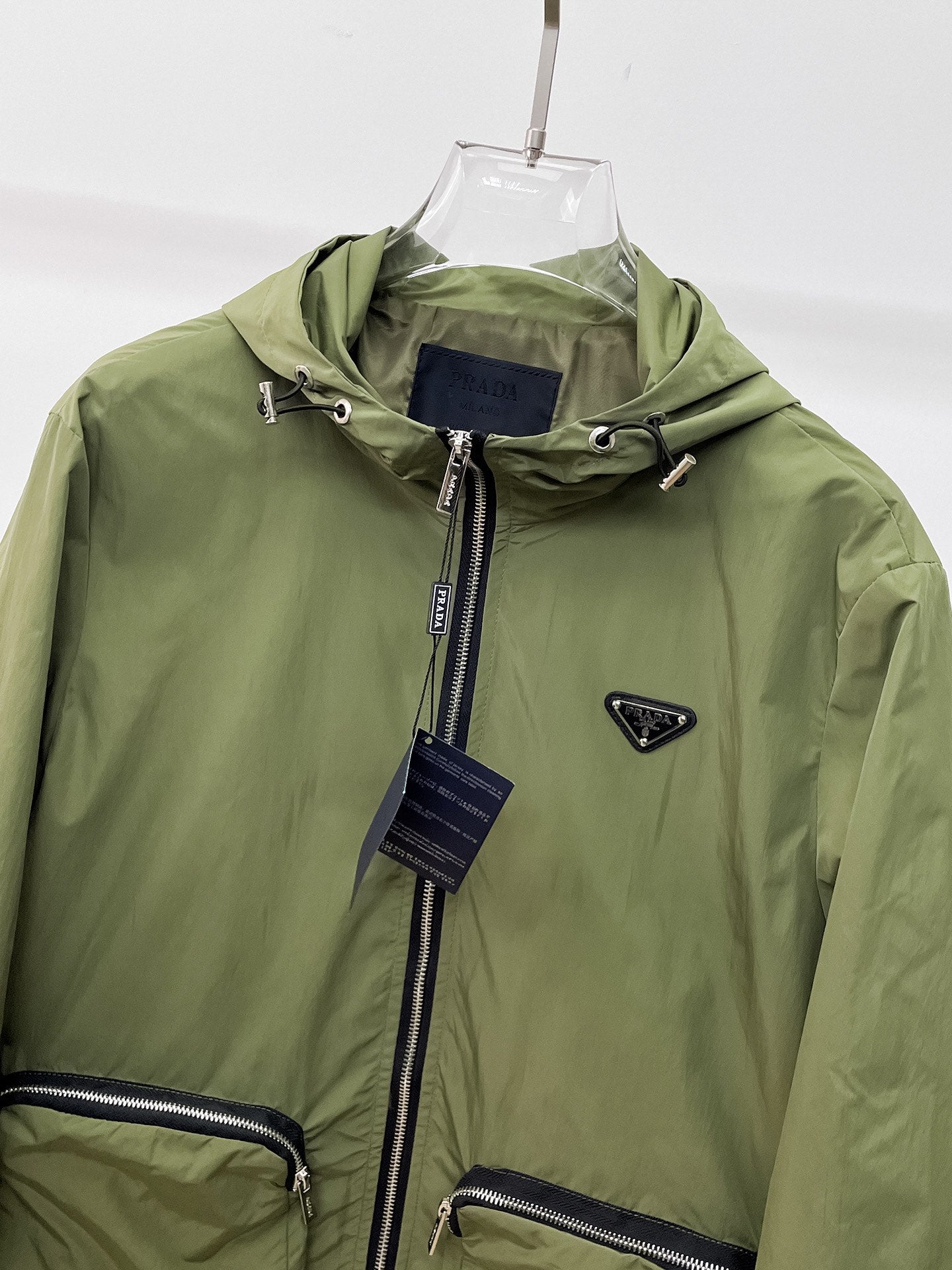 Prada hooded long jacket close-up with front zip and logo patch