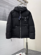Black long puffer jacket with hood, full zipper, and front flap pockets
