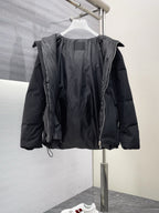 Black long puffer jacket with hood, front zipper, and visible inner paneling