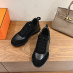 Unisex sneakers with black upper panels and black lace-up closure, gray side trim