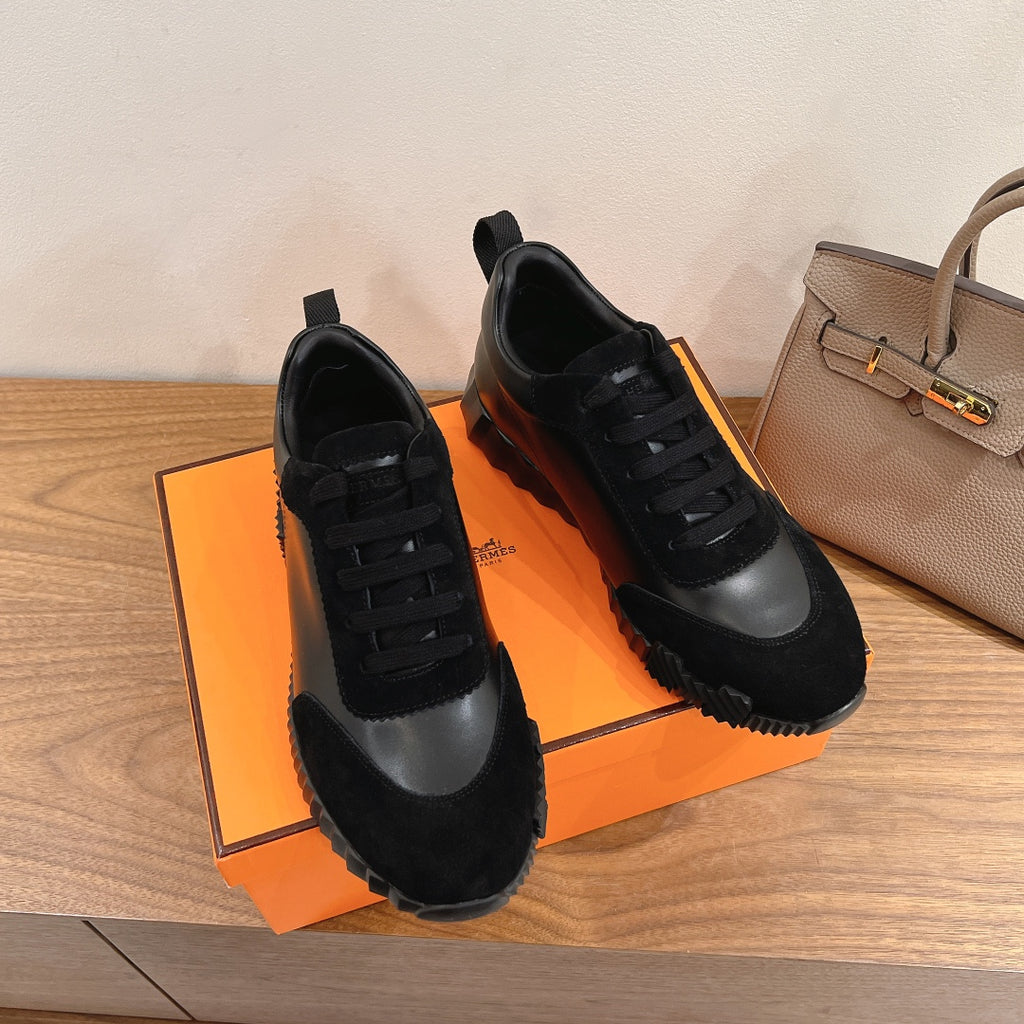 Unisex sneakers pair, black upper with gray side panel and black lace-up design