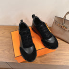 Unisex sneakers pair, black upper with gray side panel and black lace-up design