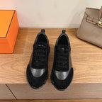 Unisex sneakers in black and gray with black laces and chunky low-profile sole